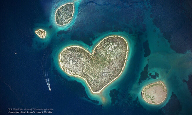 A heart-shaped island surrounded by blue water.