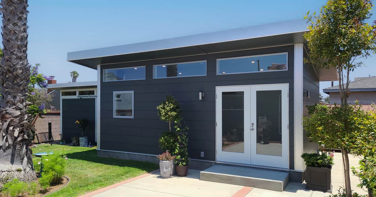 Studio Shed summit series unit with iron gray siding and white doors