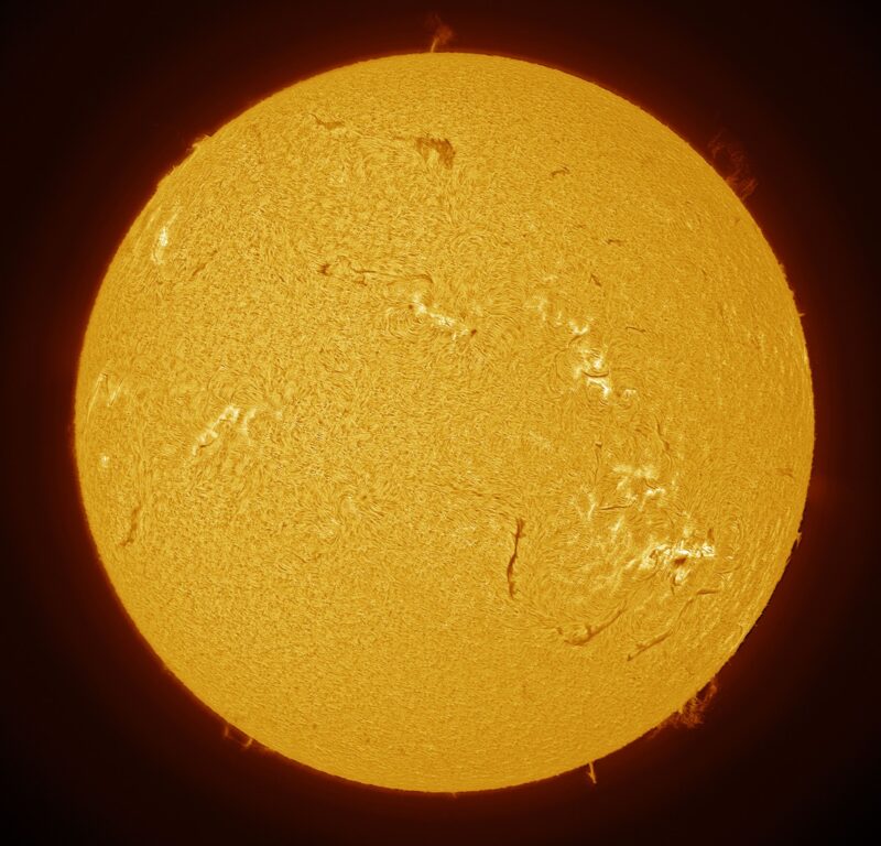 The sun, seen as a large yellow sphere with a mottled surface.