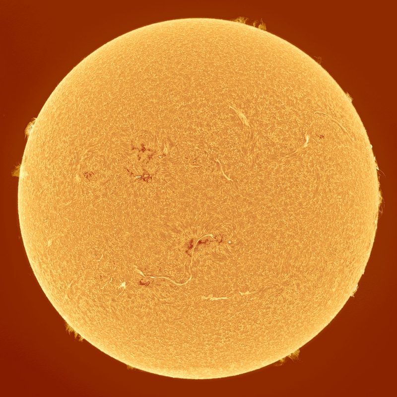 The sun, seen as a large yellow sphere with a mottled surface.