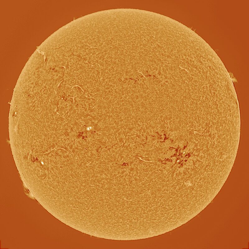 The sun, seen as a large yellow sphere with a mottled surface.