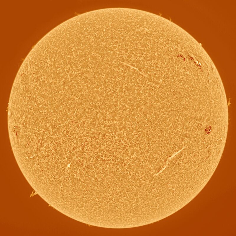 The sun, seen as a large yellow sphere with a mottled surface.