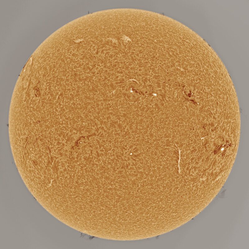 The sun, seen as a large yellow sphere with a mottled surface.