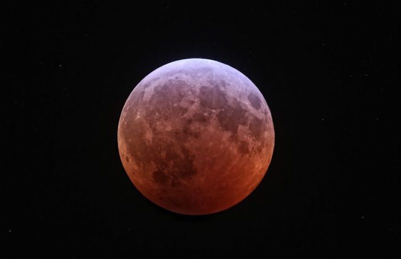 Total lunar eclipse: Lunar craters and 'seas' on the reddish moon's surface, visible during the eclipse.