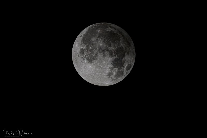 Penumbral lunar eclipse: Full moon with shading on one side.