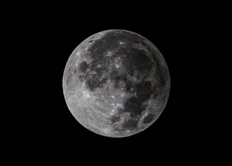 Full moon with faint shading on one side.