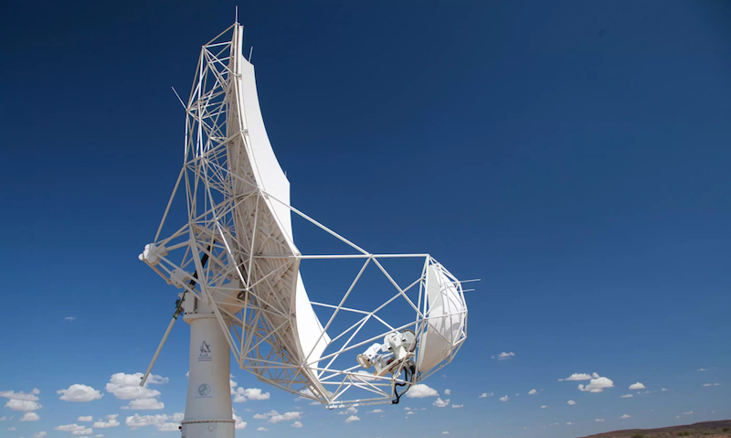 First light for SKA: Square white dish-style telescope in front of blue sky with scattered small clouds.