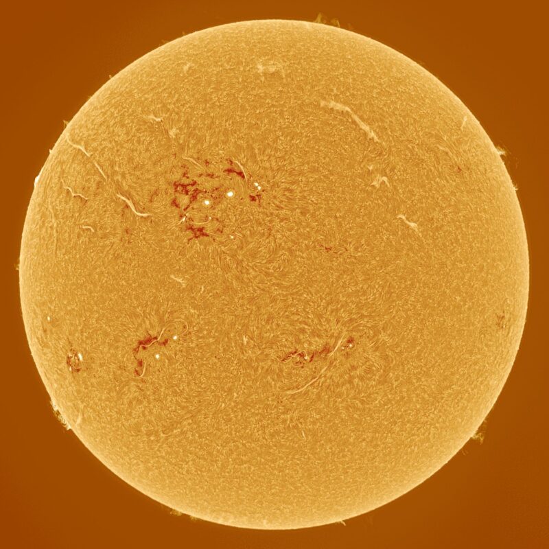 The sun, seen as a large yellow sphere with a mottled surface.