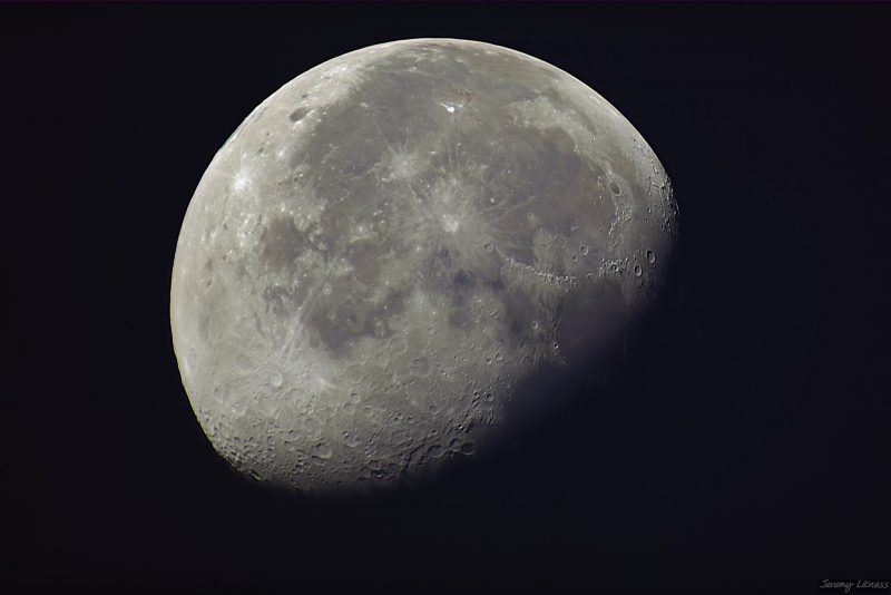 Waning gibbous moon against night sky.