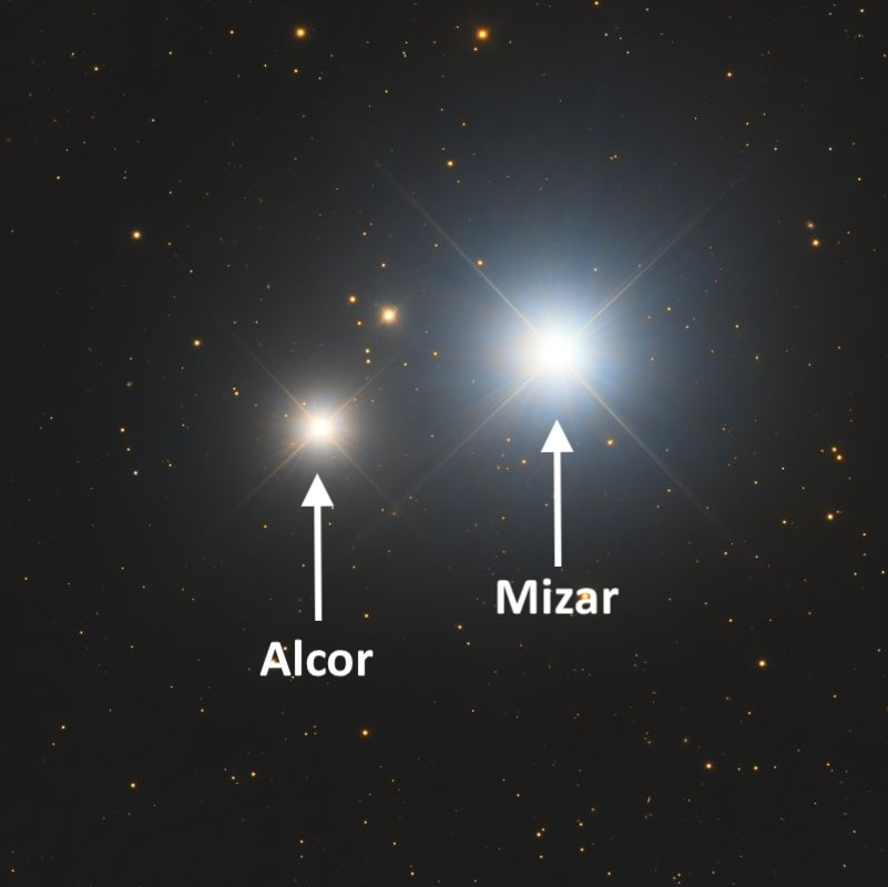 Close of up two stars, Mizar and Alcor. Alcor, on the left, is smaller and yellowish, Mizar, on the right, is bigger and whitish.